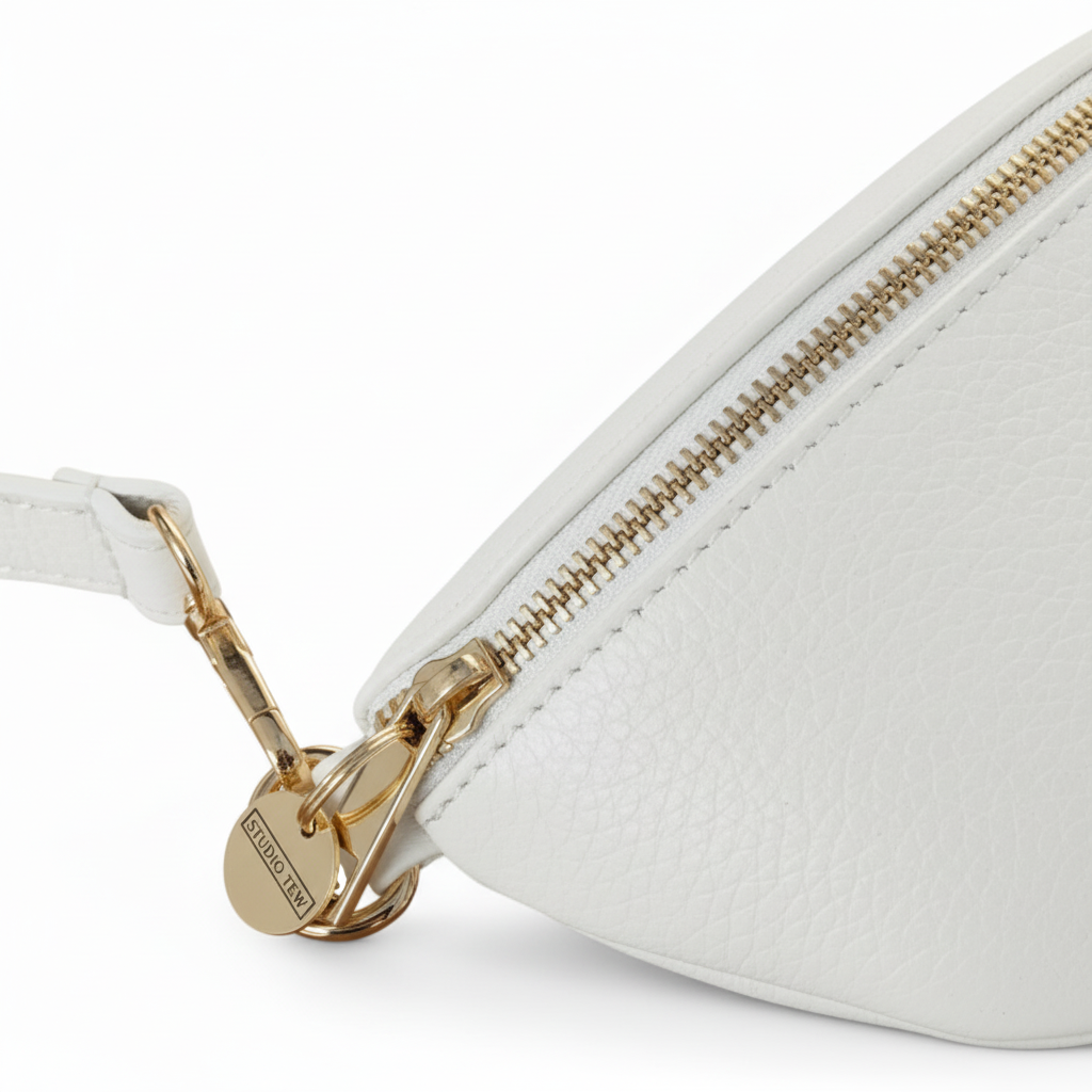 White belt bag zipper detail with STUDIO TEW tag